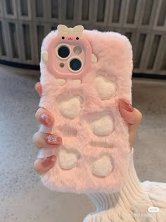 a person holding up a pink cell phone case