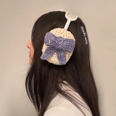 a woman wearing a crocheted hair clip with a bow on it's back