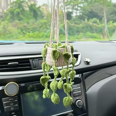 a car dashboard with an air freshener hanging from it's dash board and steering wheel