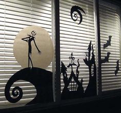 the silhouettes of halloween characters are seen through blinds in front of an open window