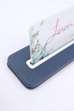 a business card holder on top of a tabletop with the name loren printed on it