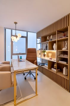 an office with a desk, chairs and shelves