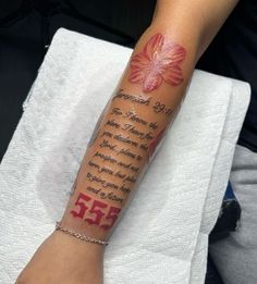 a woman's arm with a tattoo on it that reads 35 and has a pink flower