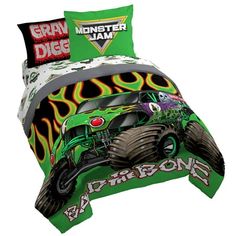 a green bed with monster trucks on it