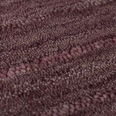 a close up view of the texture of a carpet with pink and purple colors on it