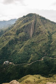 a mountain with a road going up it's side in the middle of nowhere