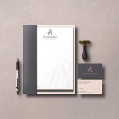 the stationery and business cards are laid out on top of each other next to a fountain pen