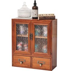 a wooden cabinet with two glass doors and an empty bottle sitting on top of it