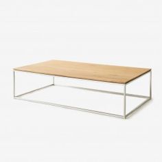 a wooden table sitting on top of a white floor next to a metal frame coffee table