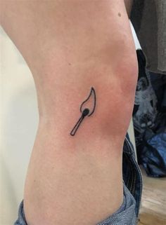 a black and white photo of a person's foot with a fork tattoo on it