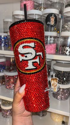 the san francisco giants glitter tumbler is red and gold with white letters on it