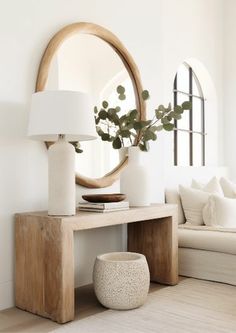 a living room with a couch, table and mirror