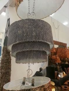 a chandelier hanging from the ceiling in a store with other items on display