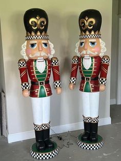 two wooden nutcrackers standing next to each other