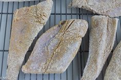 several pieces of bread sitting on top of a cooling rack next to another piece of bread