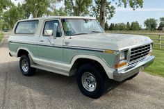 an old pick up truck is parked in the driveway