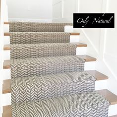 a carpeted staircase with white walls and wooden steps