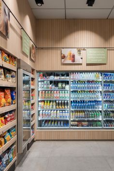 a grocery store filled with lots of different types of food and drinks on display in glass cases