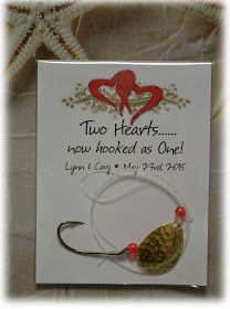 a card with a fishing hook on it's side and two hearts in the background