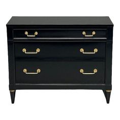 a black dresser with gold handles on it