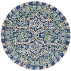 a blue and green rug with an intricate design on the center, surrounded by fringes