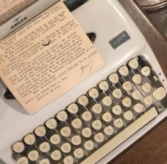 an old fashioned typewriter sitting on top of a table