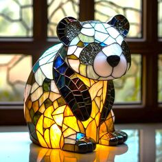 a stained glass bear sitting on top of a table