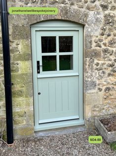 a white door sitting in front of a stone building