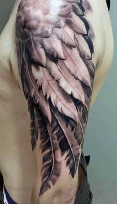 the back of a man's upper half with feathers on his arm and chest