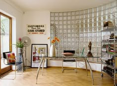 a room that has a glass block wall in it and some books on the shelves