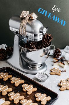 a cookie maker with cookies on the counter next to it and an image of gingerbreads