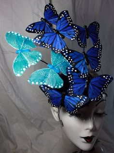 a mannequin head with blue butterflies on it