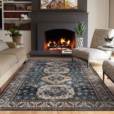 a living room filled with furniture and a fire place under a painting on the wall