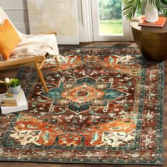 a living room area with a chair, rug and potted plant on the floor