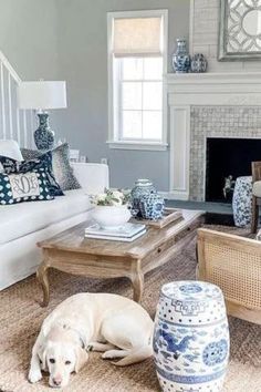 a living room filled with furniture and a fire place in the middle of a room