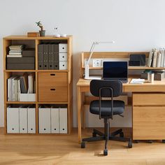 a desk with a chair and bookshelf next to it