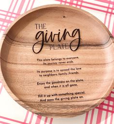 a wooden bowl with the saying giving plate on it