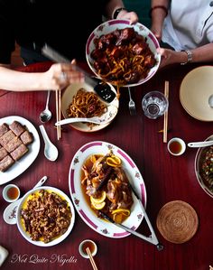 a table topped with plates and bowls filled with food