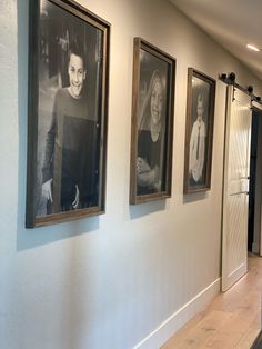 a hallway with pictures hanging on the wall