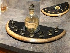 a bottle that is sitting on top of a wooden tray with metal fittings and knobs