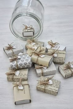 small books are wrapped in twine and tied with twine, sitting next to a glass jar