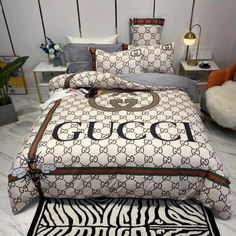 a bed with zebra print and gucci logo on it