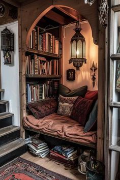 a living room filled with lots of books on top of a wooden shelf next to a stair case