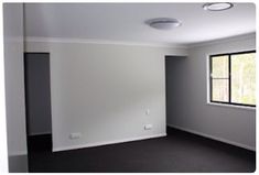 empty room with black carpet and white walls