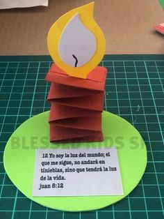 a paper candle with a bible verse on it