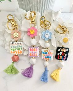 the keychains have been decorated with different designs and colors, such as happy birthday