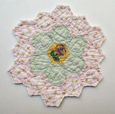 a close up of a piece of fabric with flowers and leaves on the center,