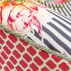 a close up view of the back of a cushion with flowers on it and stripes