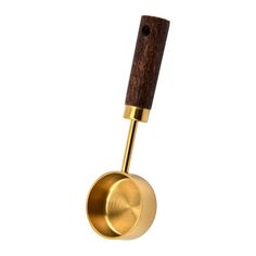 a gold colored metal object with a wooden handle