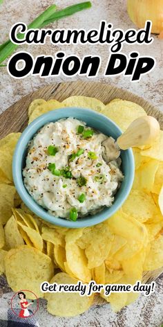 a blue bowl filled with onion dip surrounded by chips